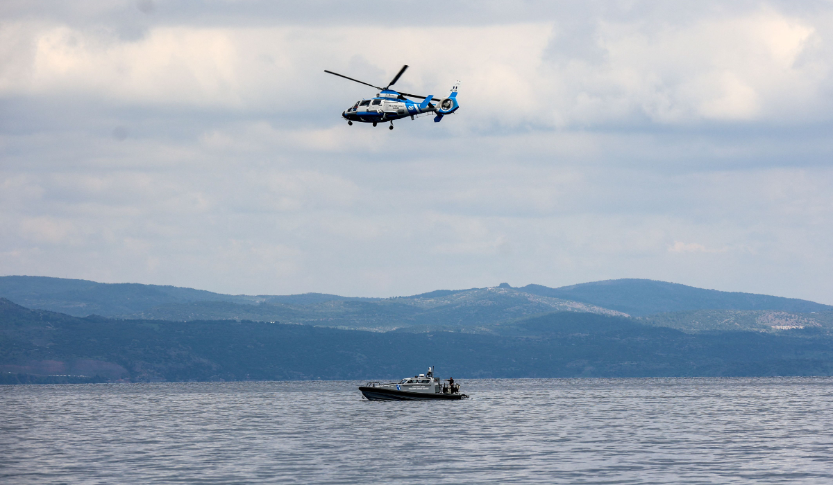 A Greek coast guard vessel and a helicopter take part in a search and rescue operation, after an inflatable boat carrying migrants capsized off on the Aegean Sea island of Lesbos on April 3, 2025. (AFP)