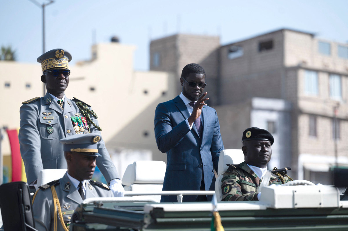Senegal's President Bassirou Diomaye Faye (2nd R) and Chief of General Staff Mbaye Cisse (L), ride on a military vehicle to review the troops during the 65th Independence Day parade on Boulevard General de Gaulle, now Boulevard Mamadou Dia, in Dakar on April 4, 2025. (AFP)