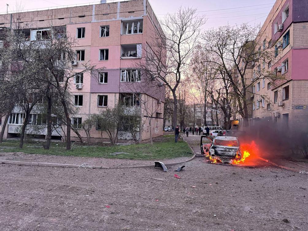 This handout photograph published in the official Telegram channel of Ukrainian President Volodymyr Zelensky on Apr. 4, 2025, shows a burning car next to damaged buildings in Kryvyi Rig, after a reported missile strike. (AFP)
