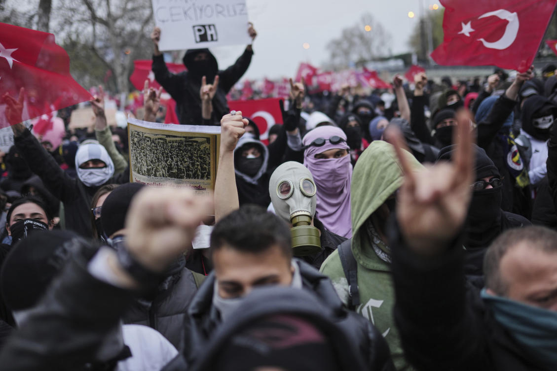 People shout slogans during a protest after Istanbul's Mayor Ekrem Imamoglu was arrested and sent to prison, in Istanbul, Turkey, Sunday, March 23, 2025. (AP Photo/Francisco Seco)