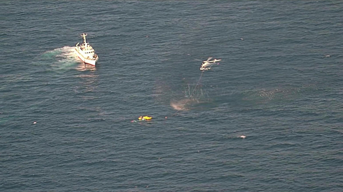 A coast guard vessel and a helicopter conduct a rescue operation after a medical transport helicopter fell into the sea in southwestern Japan on April 6, 2025. (The 7th Regional Japan Coast Guard Headquarters via AP)