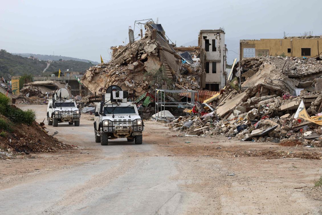 United Nations peacekeepers drive in vehicles of the UN Interim Force in Lebanon (UNIFIL) past destroyed buildings while patroling in Lebanon's southern village of Kfar Kila close to the border with Israel on April 6, 2025. (AFP)
