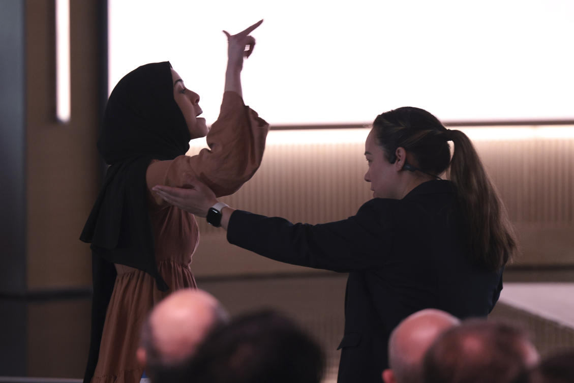 A pro-Palestinian demonstrator, Ibtihal Aboussad, is escorted away by security as they interrupt Microsoft's 50th anniversary celebration in Redmond, Washington, Apr. 4, 2025. (AP)