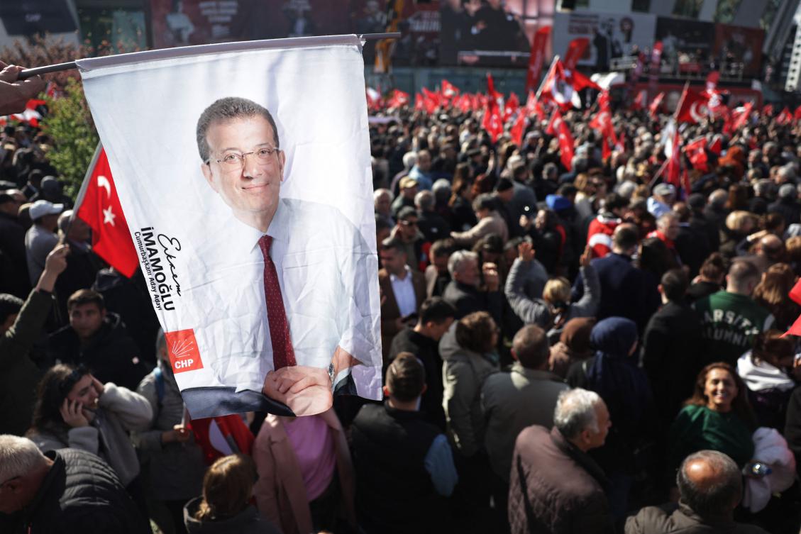A supporter holds a poster of jailed Istanbul mayor Ekrem Imamoglu during a meeting of Turkiye’s main opposition Republican People’s Party in Ankara on April 6, 2025. (AFP)