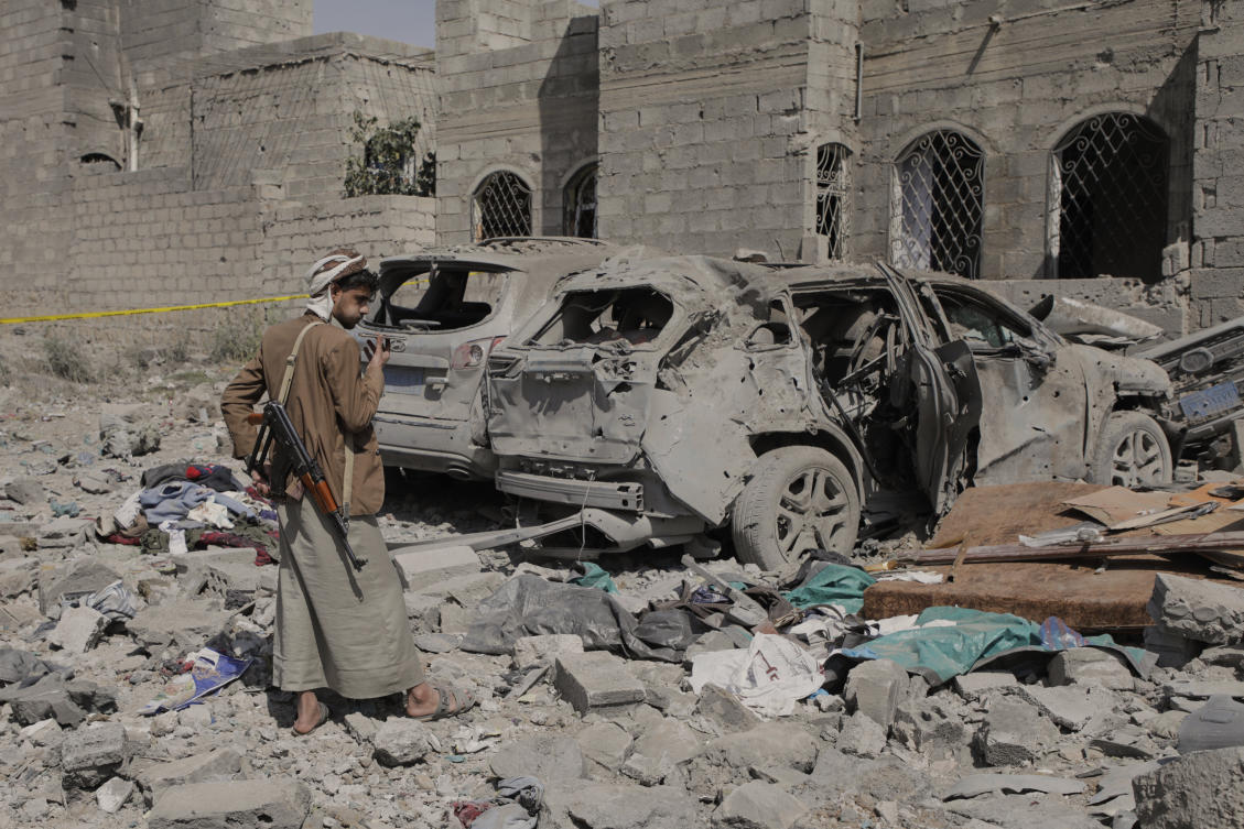 A Yemeni inspects the damage reportedly caused by US airstrikes in Sanaa, Yemen on Monday. (AP)