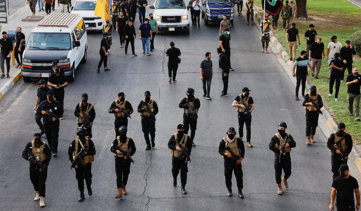 A vehicle carries the coffin of a commander from Iraq's Kataib Hezbollah armed group who was killed in what they called a "Zionist attack" in the Syrian capital Damascus on Friday, during a funeral in Baghdad, Iraq September 22, 2024. (REUTERS)