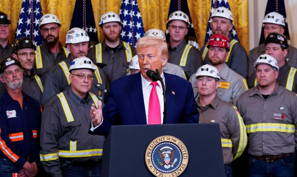 US President Donald Trump speaks next to coal industry workers, on the day he signs energy-related executive orders at the White House in Washington, DC, US, April 8, 2025. (Reuters)