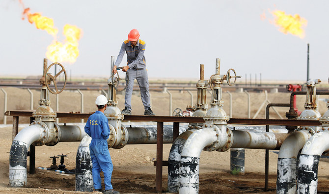Iraqi laborers work at an oil refinery in the southern town Nassiriya. (AFP/File)