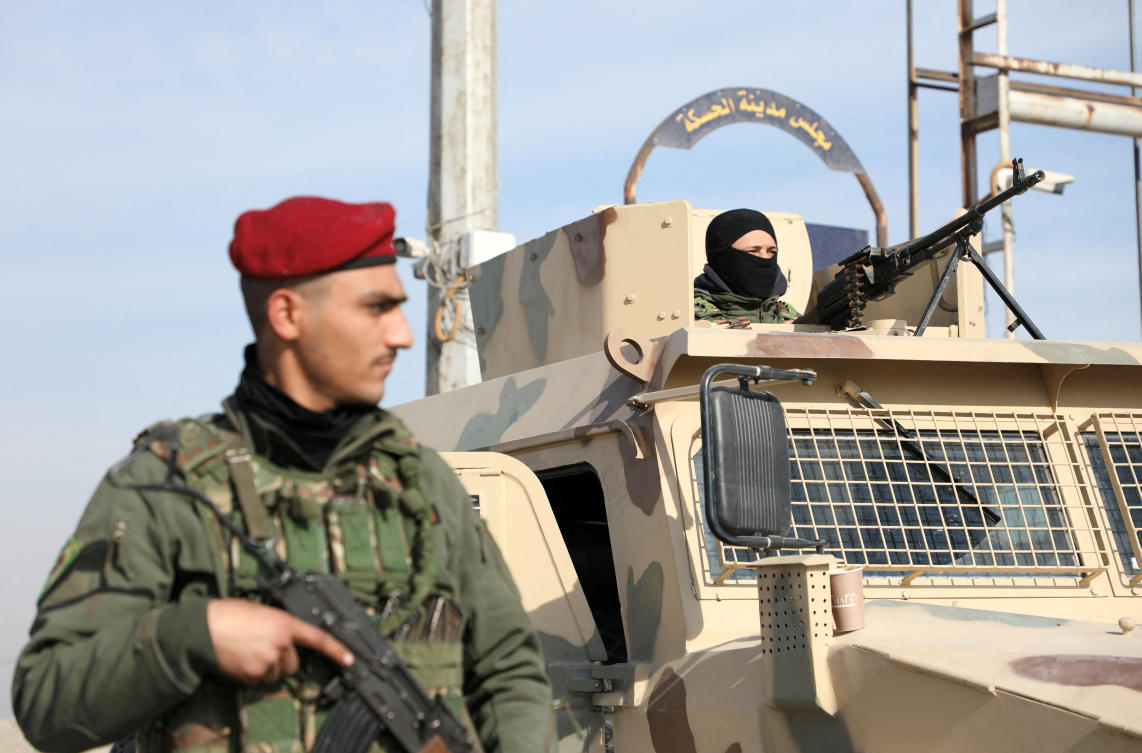 A member of Kurdish-led Syrian Democratic Forces (SDF) stands along a street, after rebels seized the capital and ousted Syria's Bashar Assad, in Hasakah, Syria in December. (Reuters)