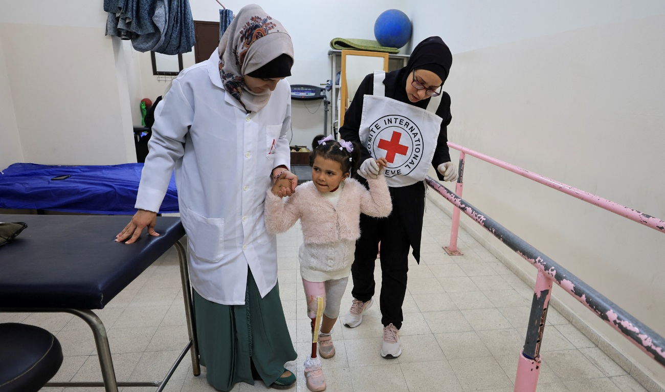 Palestinian girl Silla Abu Aqleen, who lost her right leg in an Israeli attack, is trained to walk with at the Artificial Limbs and Polio Center in Gaza City. (File/Reuters)
