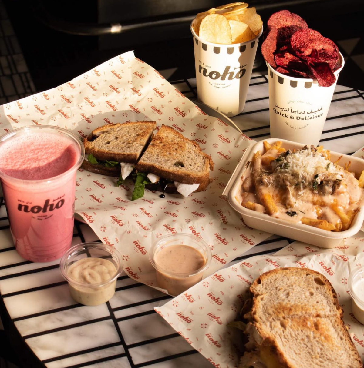 New York vibes in Riyadh — hearty deli sandwiches, crispy chips, beefy cheese fries, and a fresh smoothie from Noho Deli. Comfort food done right. (X @nohodeli)