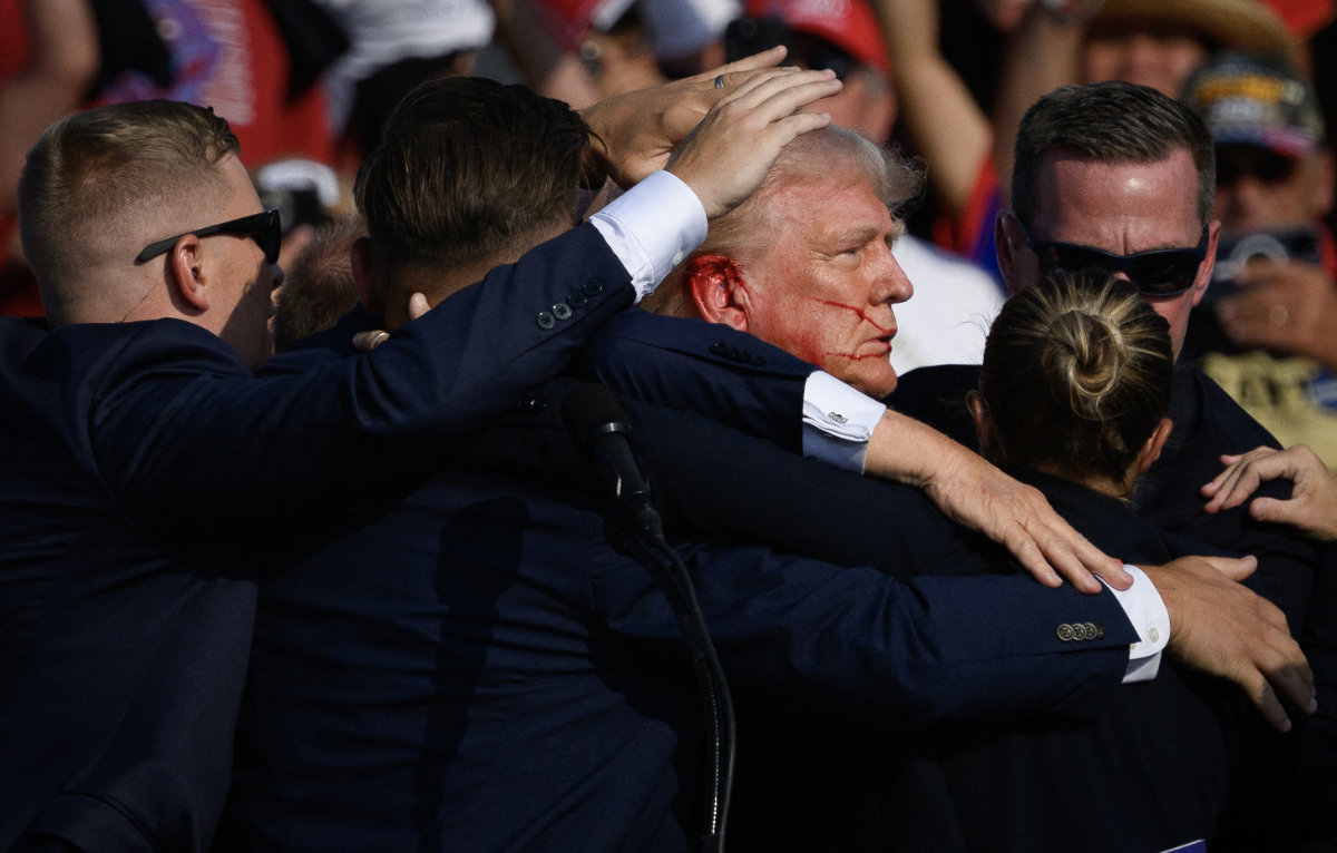 After being shot in the ear, Republican presidential candidate former President Donald Trump is protected by members of the US Secret Service while being rushed offstage during a rally on July 13, 2024 in Butler, Pennsylvania. (AFP File)
