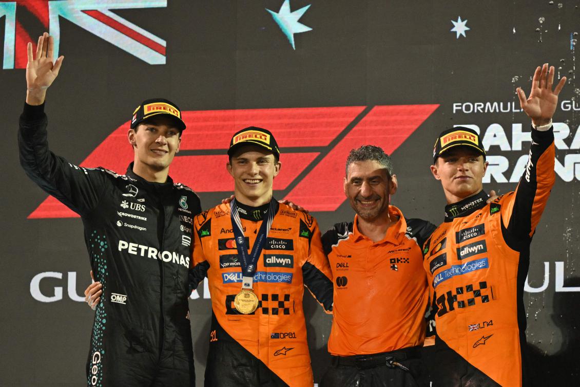 Mercedes’ British driver George Russell, McLaren’s Australian driver Oscar Piastri, McLaren team principal Andrea Stella and McLaren’s British driver Lando Norris pose on the podium after the Bahrain Formula One Grand Prix at the Bahrain International Circuit in Sakhir on April 13, 2025. (AFP)