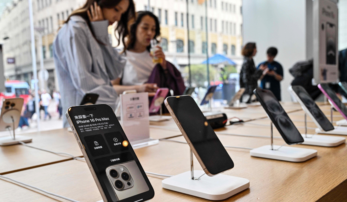 People browse for Iphone 16 displayed in a Apple store in the Huangpu district in Shanghai on April 11, 2025. (AFP)