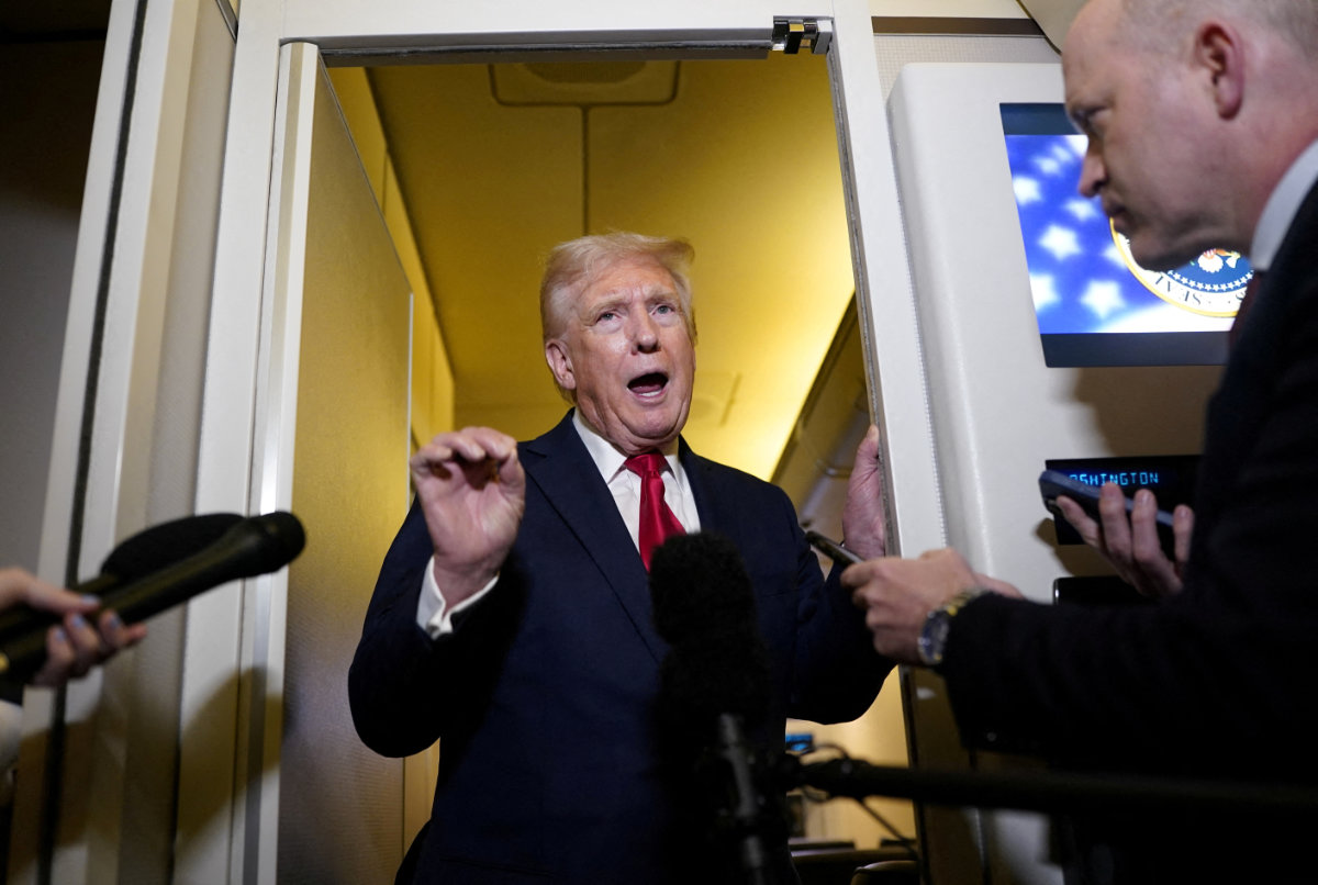 US President Donald Trump speaks to members of the media onboard Air Force One on a flight to Joint Base Andrews in Maryland on April 13, 2025. (REUTERS)