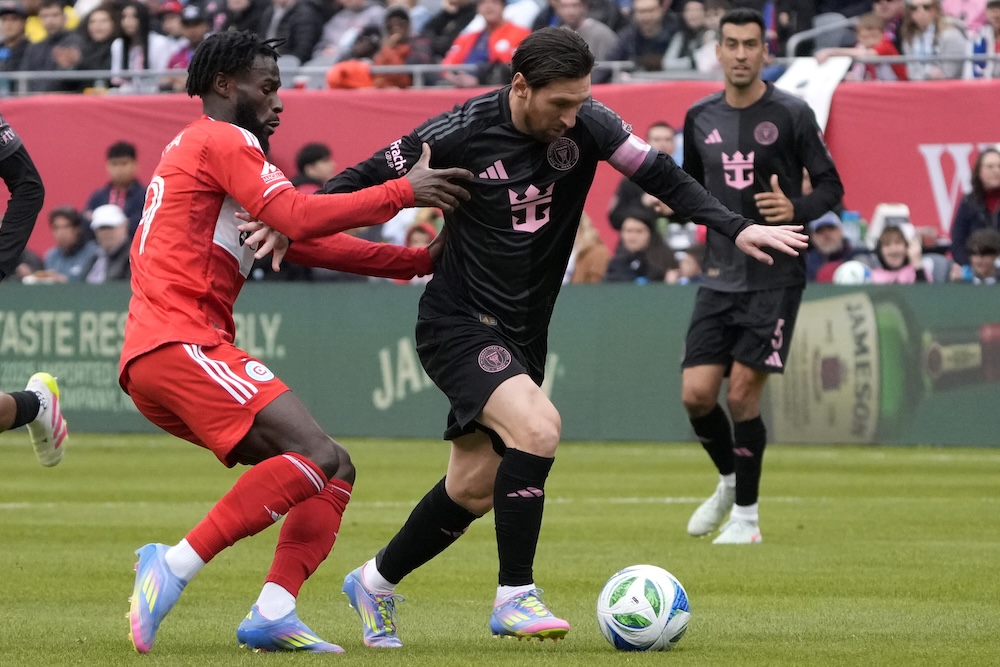 Chicago Fire forward Jonathan Bamba, left, defends Inter Miami forward Lionel Messi during the second half of an MLS football game Sunday in Chicago. (AP)