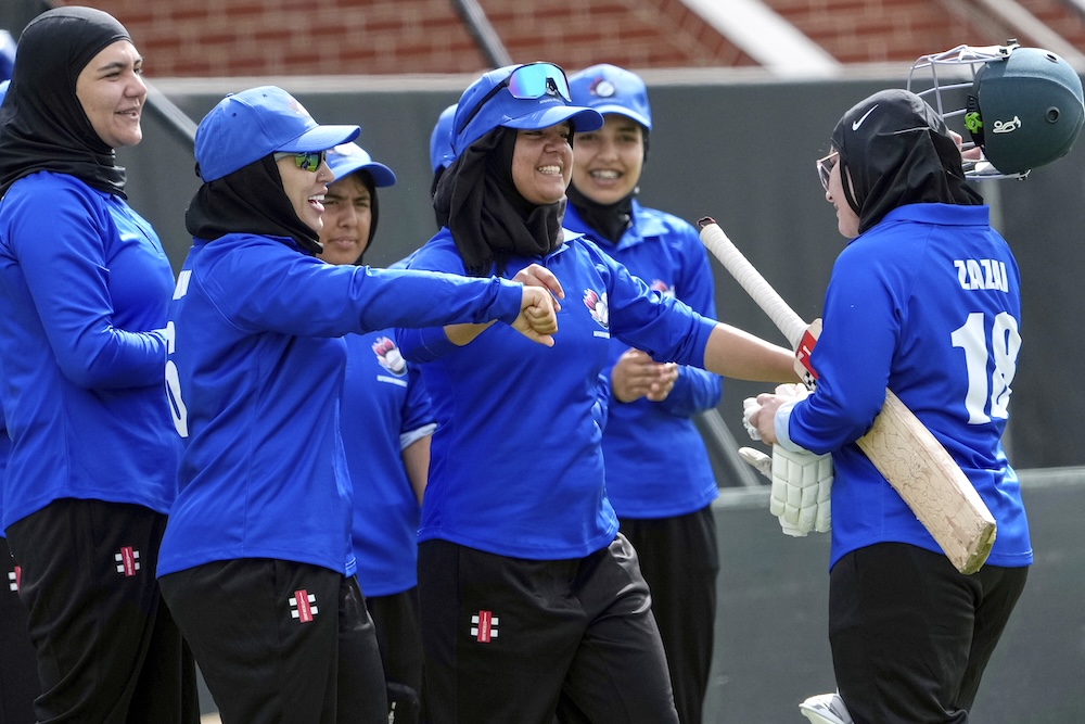 Afghan players congratulate top scoring batter Zazai as she walks off the field during their match against Cricket Without Borders XI at Junction Oval, Melbourne, on Jan. 30, 2025. (AP)