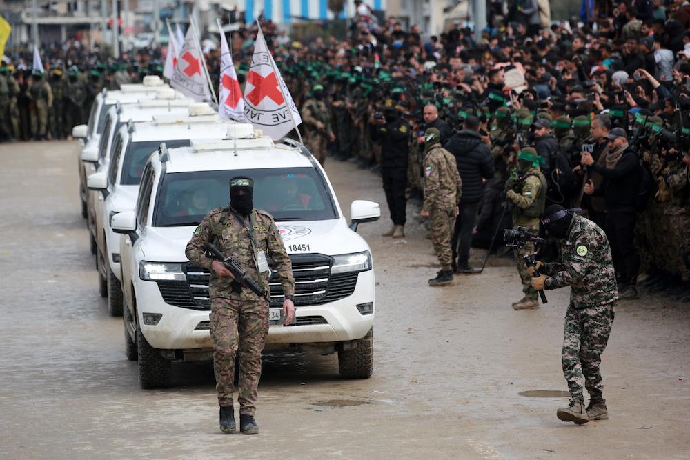 Hamas fighters escort International Red Cross vehicles during a hostage-prisoner swap ceremony on Feb. 22, 2025. (AFP file photo)