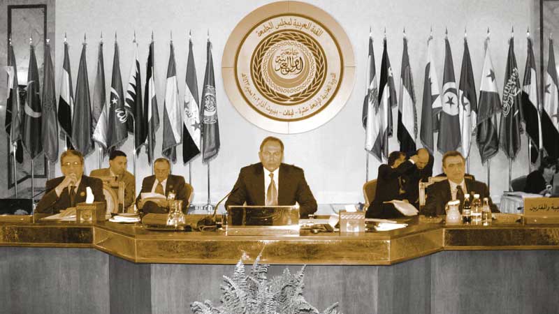 Lebanese President Emile Lahoud (C) sits between Arab League Secretary- General Amr Mussa (L) and Lebanese Foreign Minister Mahmoud Hammud (R) as he opens the Arab Summit in Beirut, where the Saudi-backed proposal to end the Arab–Israeli conflict was adopted. AFP