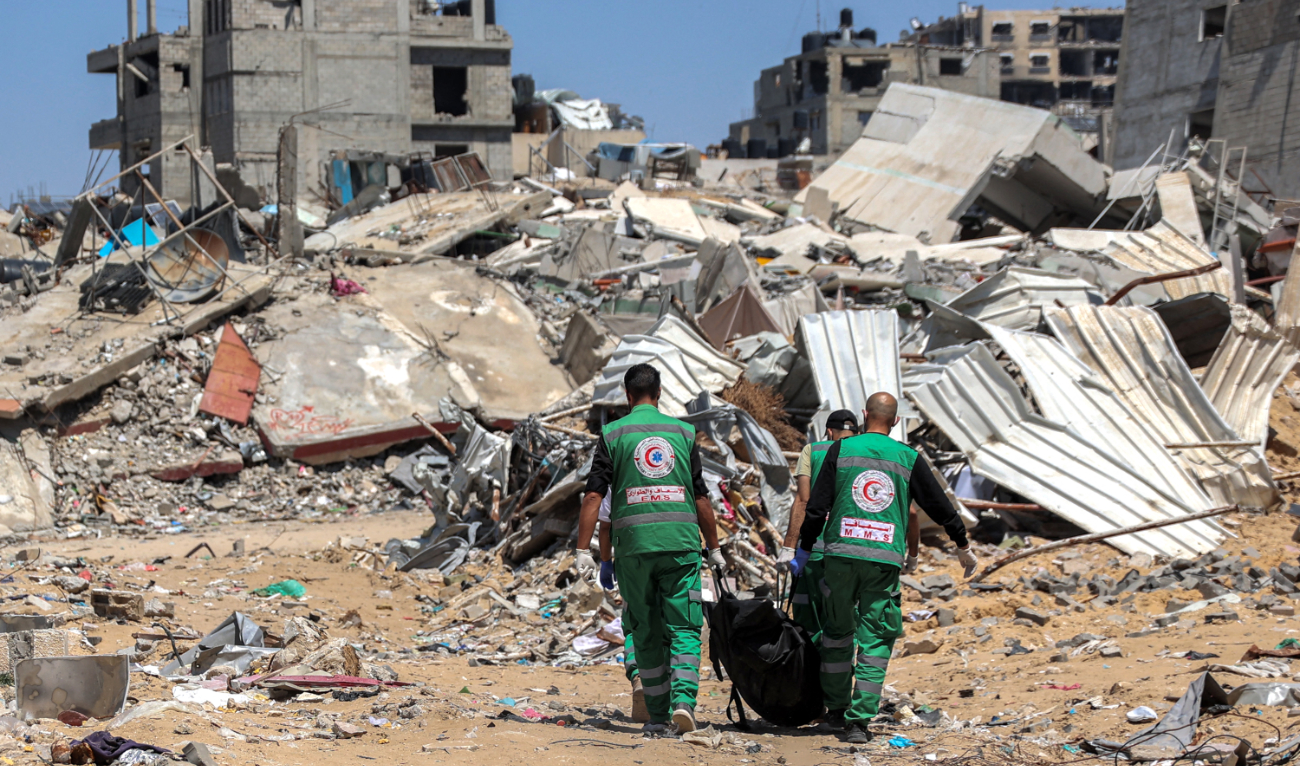 Palestinian paramedics carry away bodies of dead people uncovered in the vicinity of Al-Shifa Hospital in Gaza City on April 17, 2024. (AFP)