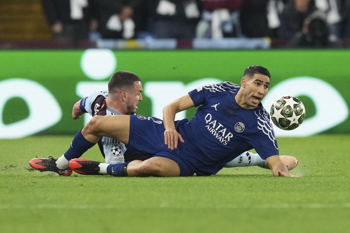 PSG’s Achraf Hakimi, right falls after a challenge by Aston Villa’s John McGinn during their Champions League quarterfinal second leg soccer match at the Villa Park stadium, in Birmingham, Apr. 15, 2025. (AP)