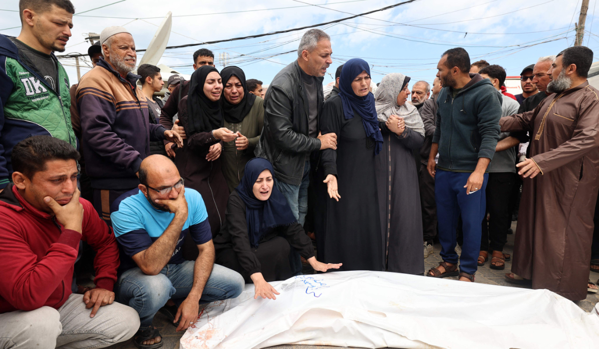 elatives mourn over the bodies of Palestinians killed in an Israeli strike, at the al-Aqsa Martyrs hospital in Deir el-Balah in the central Gaza Strip on April 13, 2025. (AFP)