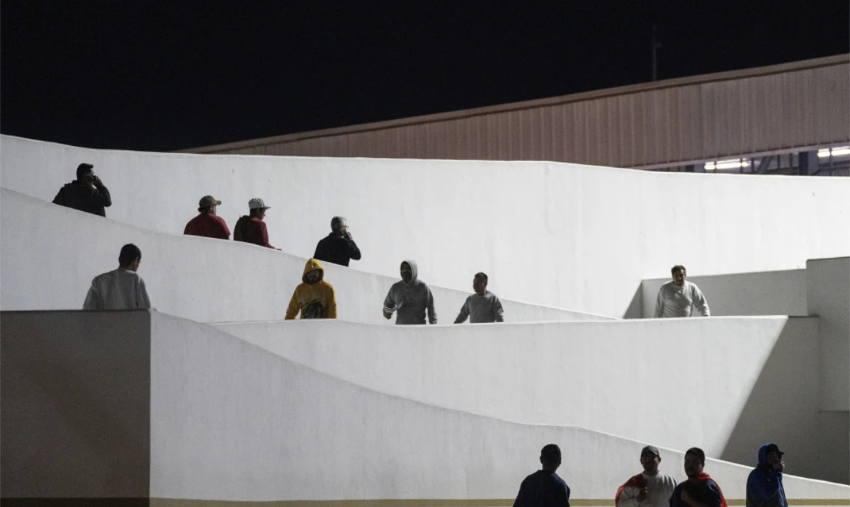 Migrants walk into Mexico after being deported from the United States at El Chaparral pedestrian border bridge in Tijuana, Mexico. (AP/File)