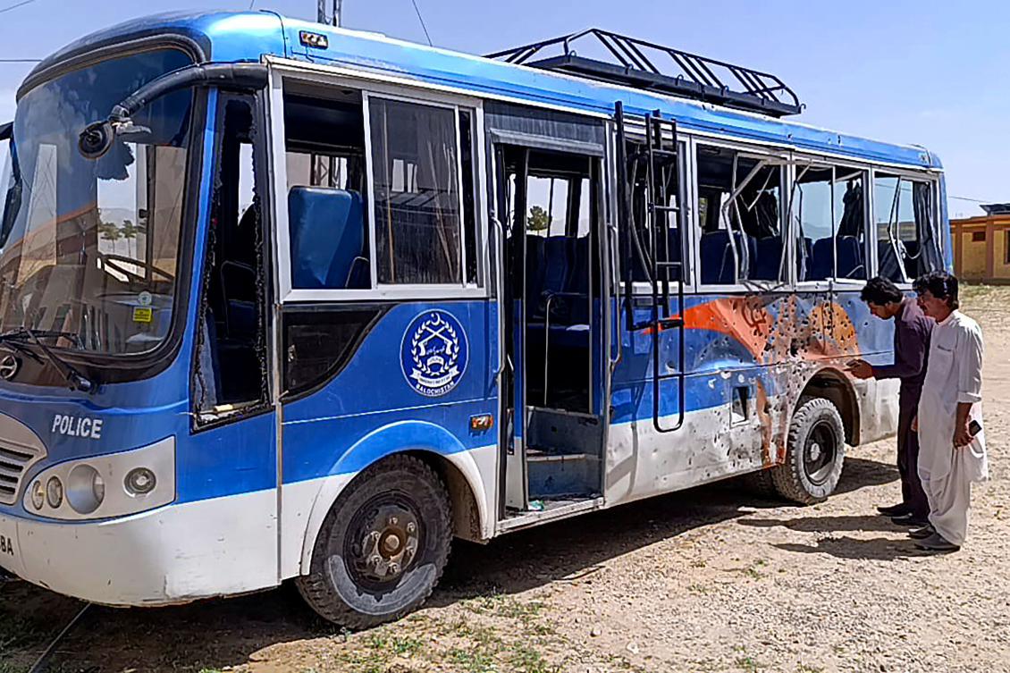 People look at a damaged police bus parked in a security compound following a bomb explosion in Mastung district on April 15, 2025. An explosion targeting a police bus in Pakistan’s southwestern Balochistan province killed at least three officers and wounded 16 others on April 15, authorities said. (AFP)