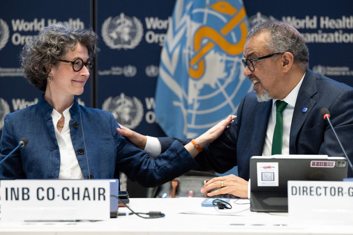 Co-chair of the negotiations and French ambassador for Global Health Anne-Claire Amprou (L) and WHO Director-General Tedros Adhanom Ghebreyesus after a consensus on the Pandemic Agreement at the WHO headquarters. (AFP)