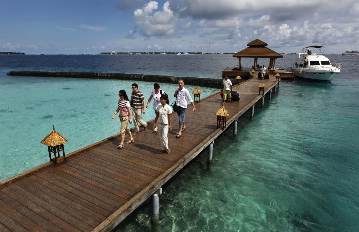 Foreign tourists arrive in a resort in the Kurumba island in Maldives. (File/AP)