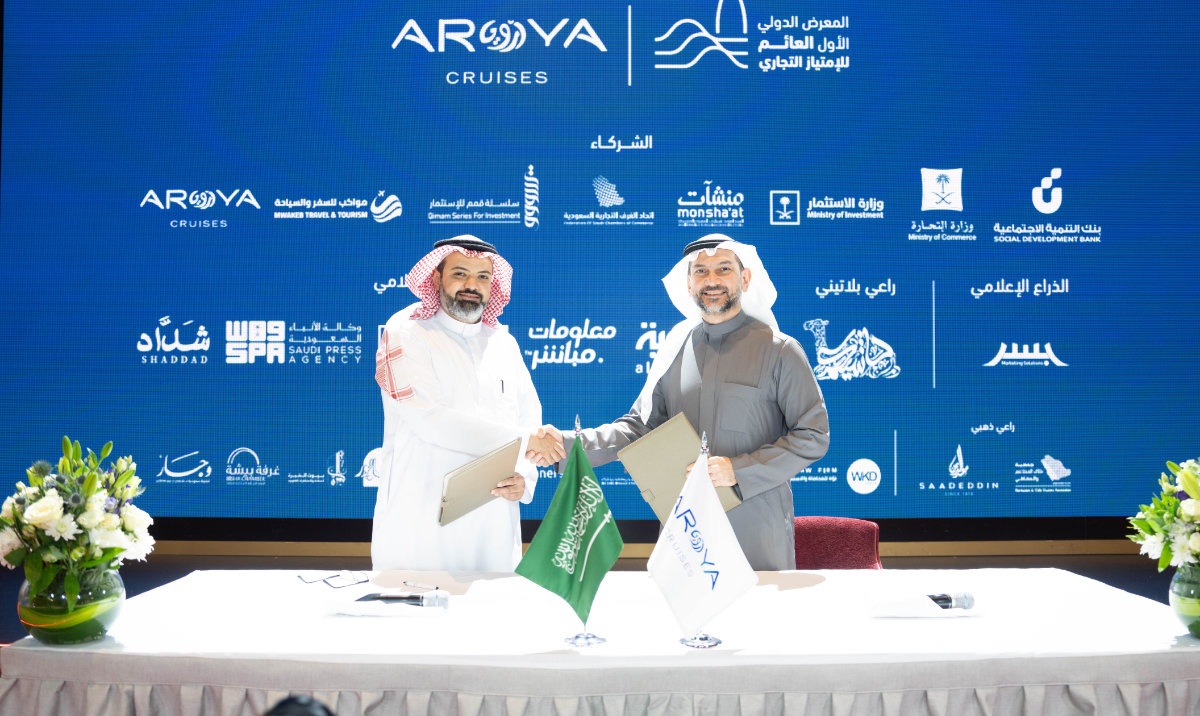 Dr. Khalid Al-Ghamdi, left, chairman of the National Franchise Committee, and Alaa Tashkandi, general sales manager at AROYA Cruises, shake hands after signing the agreement. (Supplied)