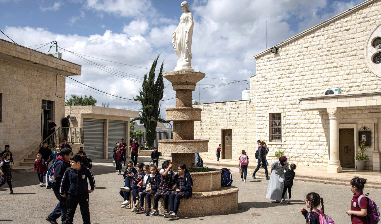 Students walk through a Christian school in the Palestinian town of Zababdeh, Israeli-occupied West Bank. (AFP)