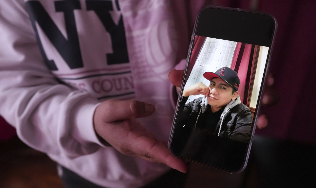 Marilu Domingo Ortiz, whose husband was taken into custody by ICE agents after they smashed a window of their family car, shows a photograph of her spouse, Juan Francisco Mendez, at their home, Wednesday, April 16, 2025, in New Bedford, Mass. (AP)