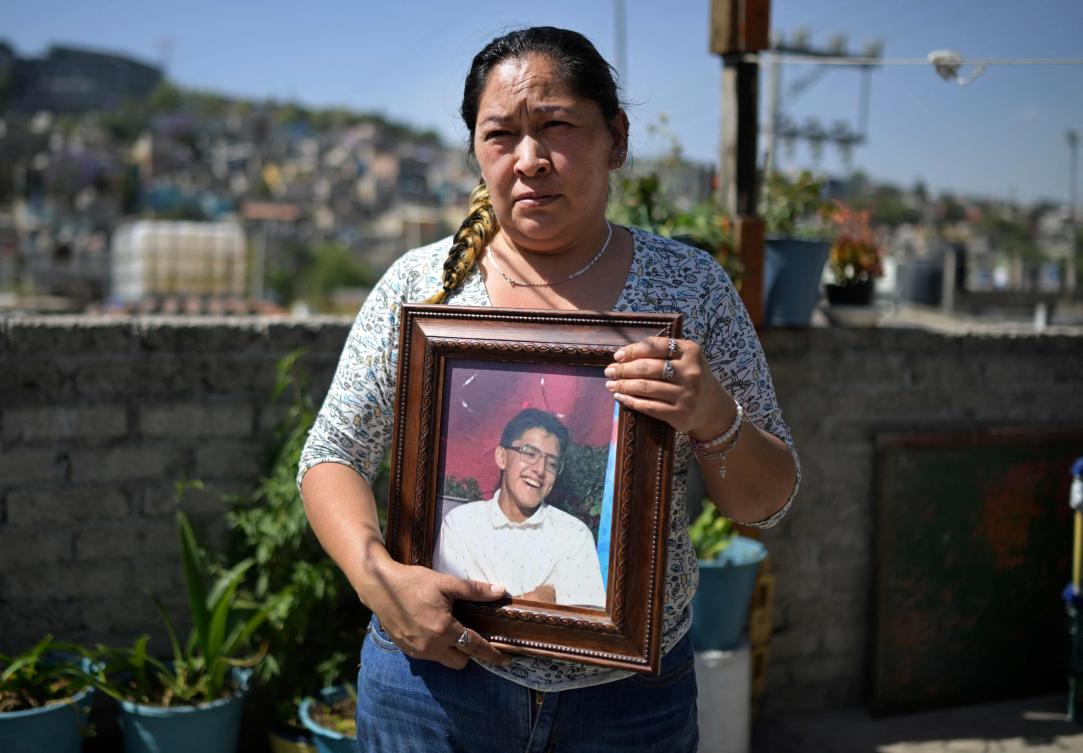 Veronica Cruz holds a portrait of her missing son Robert Reyes in the Valle Dorado neighborhood, Naucalpan municipality, State of Mexico on April 7, 2025. (AFP)
