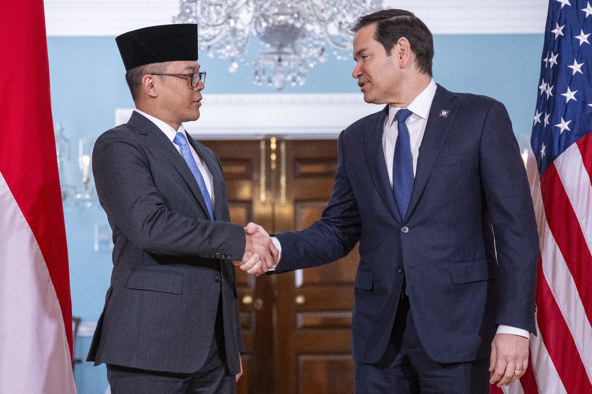 US Secretary of State Marco Rubio (R) shakes hands with Indonesian Foreign Minister Sugiono