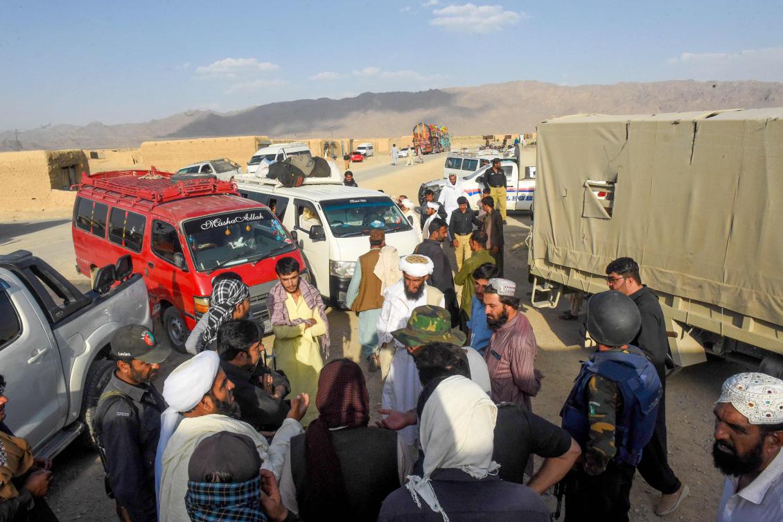 Police officials interrogate Afghan refugees before their departure for Afghanistan, at a camp in Panjpai area on the outskirts of Quetta on April 16, 2025. (AFP)