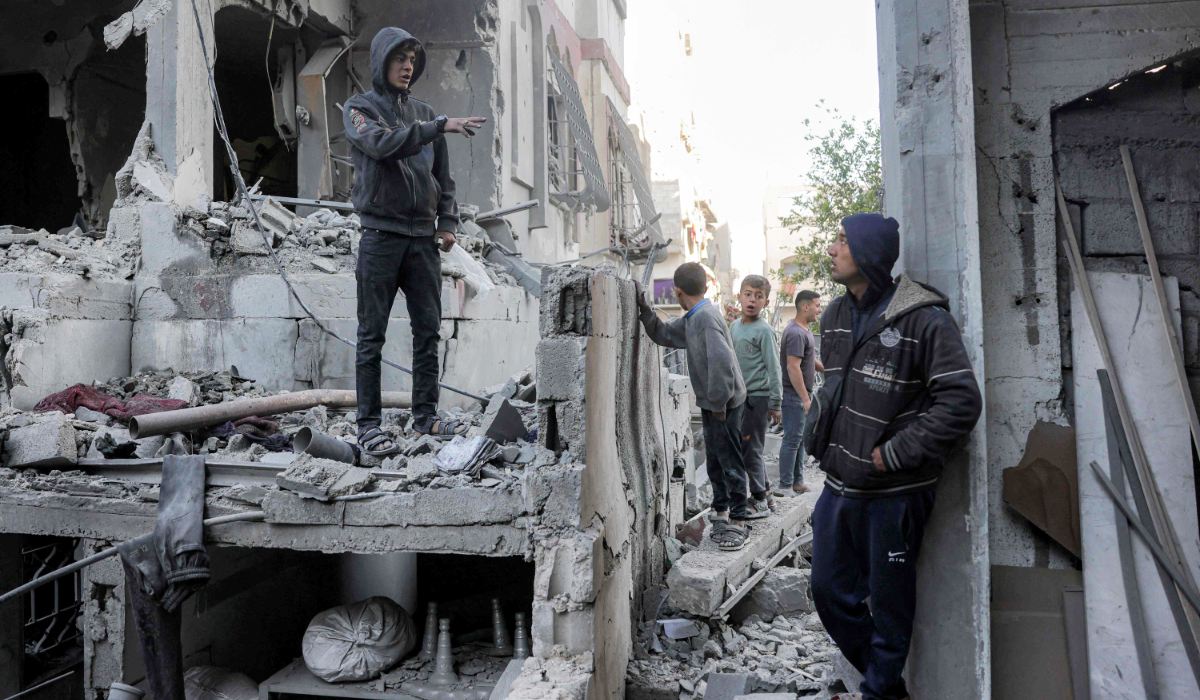 Boys inspect the rubble of a destroyed building that was hit by Israeli bombardment in Jabalia in the northern Gaza Strip on Friday. (AFP)