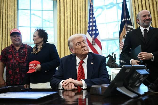 US President Donald Trump and Commerce Secretary Howard Lutnick (R) look on before Trump signed a proclamation expanding fishing rights in the Pacific islands. (AFP)