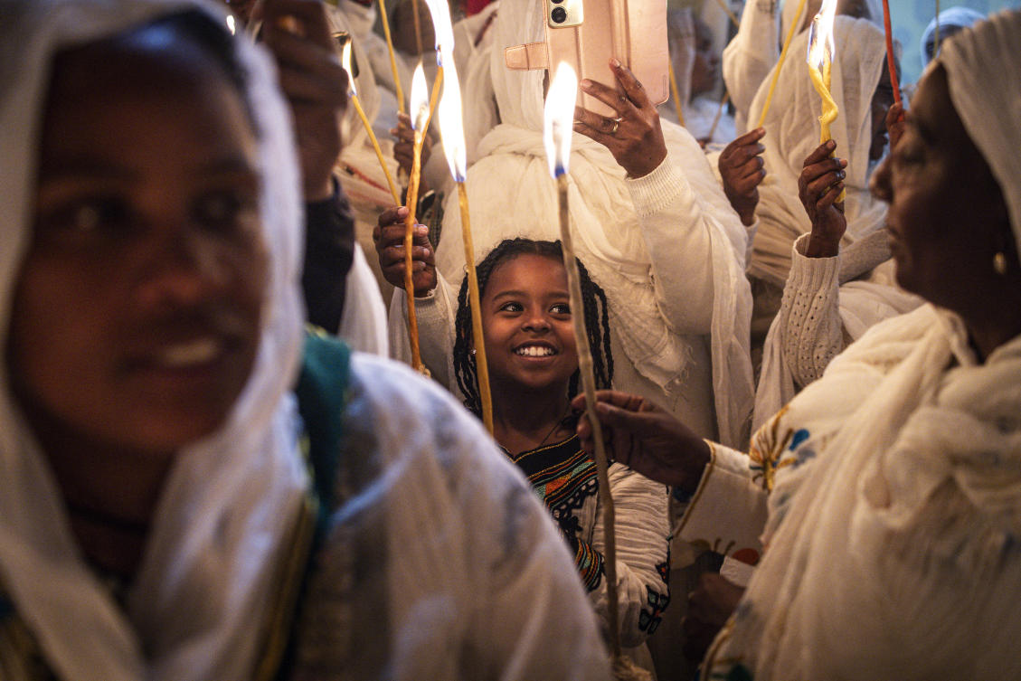 Ethiopian Orthodox Christian pilgrims light candles during the ceremony of the "Holy Fire" at the Deir Al-Sultan Monastery (AFP)