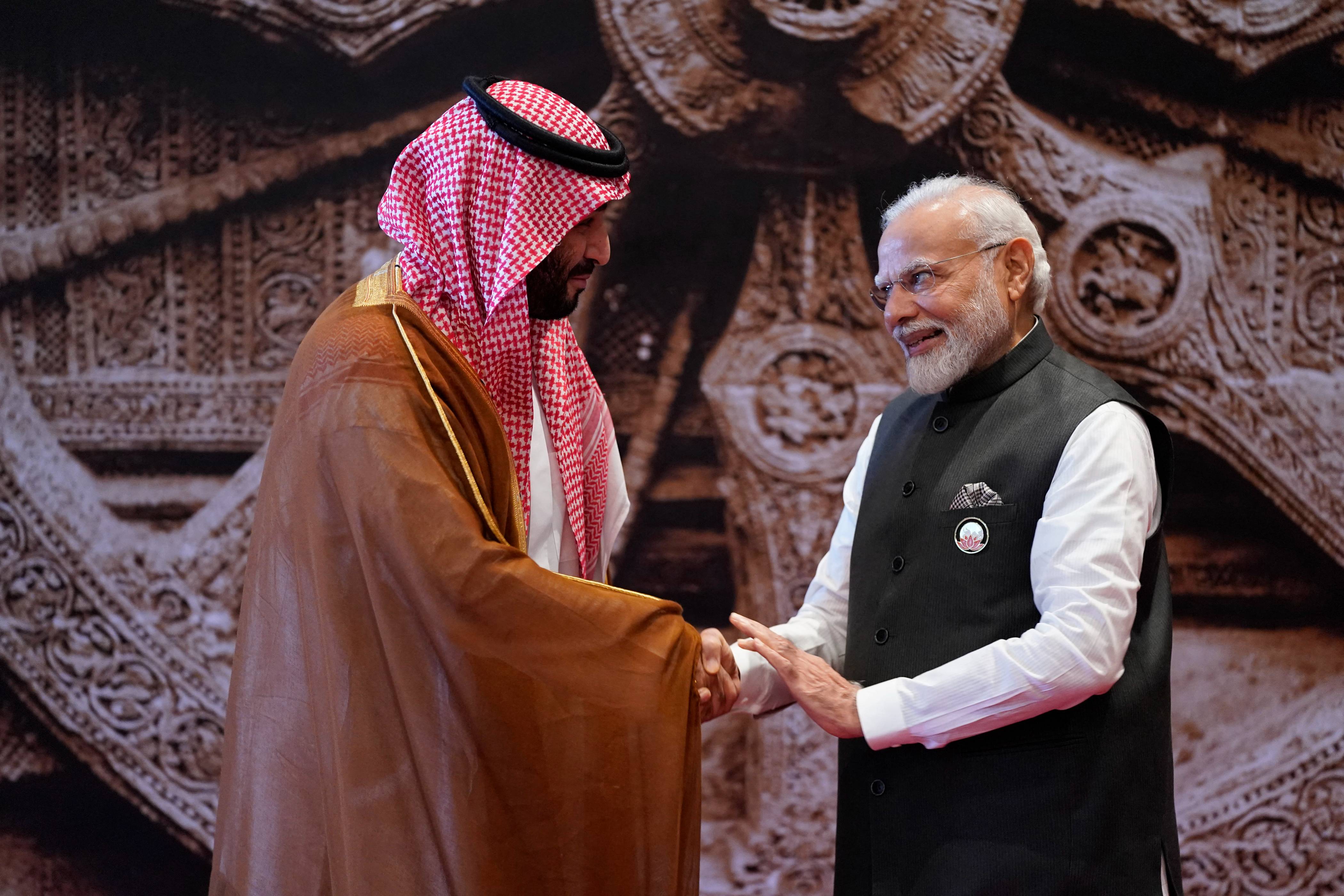 India's Prime Minister Narendra Modi, right, shakes hand with Saudi Arabia's Crown Prince and Prime Minister Mohammed bin Salman ahead of the G20 Leaders' Summit in New Delhi on Sept.9, 2023. (AFP)