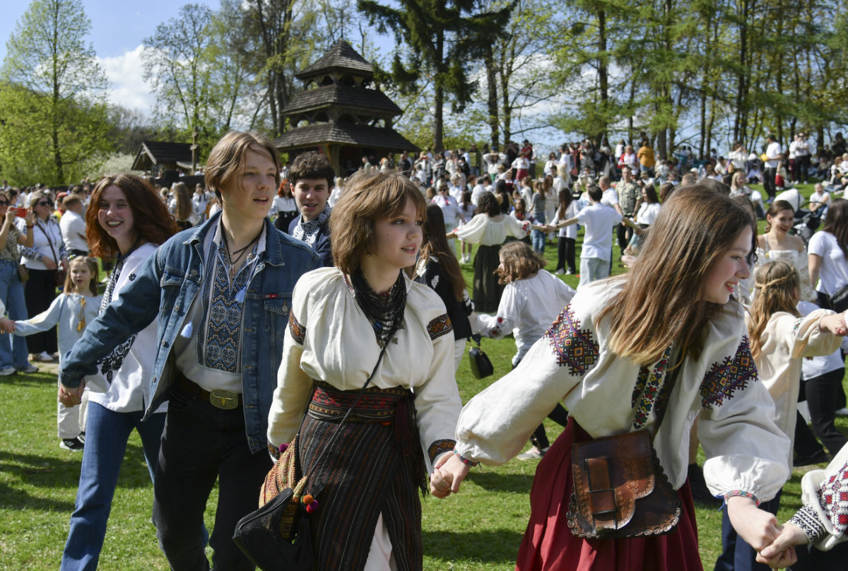 Ukrainians dressed in traditional national costumes attend the Easter Mass celebration at the Museum of Folk Architecture and Life in Lviv, western Ukraine, on April 20, 2025, amid the ongoing Russian invasion. (EPA)
