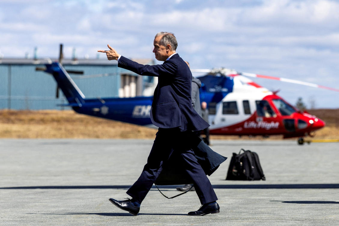 Canada’s PM Mark Carney walks toward a bus in Halifax Stanfield International Airport, during his Liberal Party election campaign tour in Goffs, Nova Scotia, Canada, Apr. 21, 2025. (Reuters)