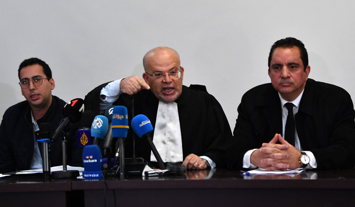 Samir Dilou (C), lawyer and member of the defence committee of detainees accused of involvement in a conspiracy case against state security, talks to reporters in in front of the court in Tunis, on April 21, 2025. (AFP)