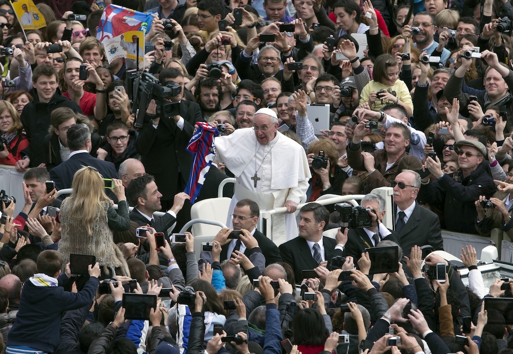 Pope Francis holds a San Lorenzo football jersey after celebrating his first Easter Mass in St. Peter’s Square at the Vatican on March 31, 2013. (AP file photo)