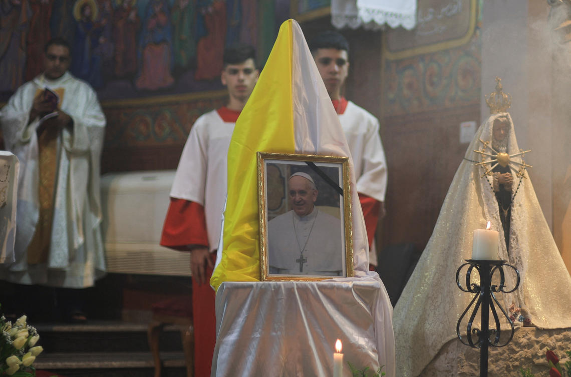 A portrait of Pope Francis is displayed during a Mass at the Holy Family Church, after his death was announced, in Gaza City, April 21, 2025. (Reuters)
