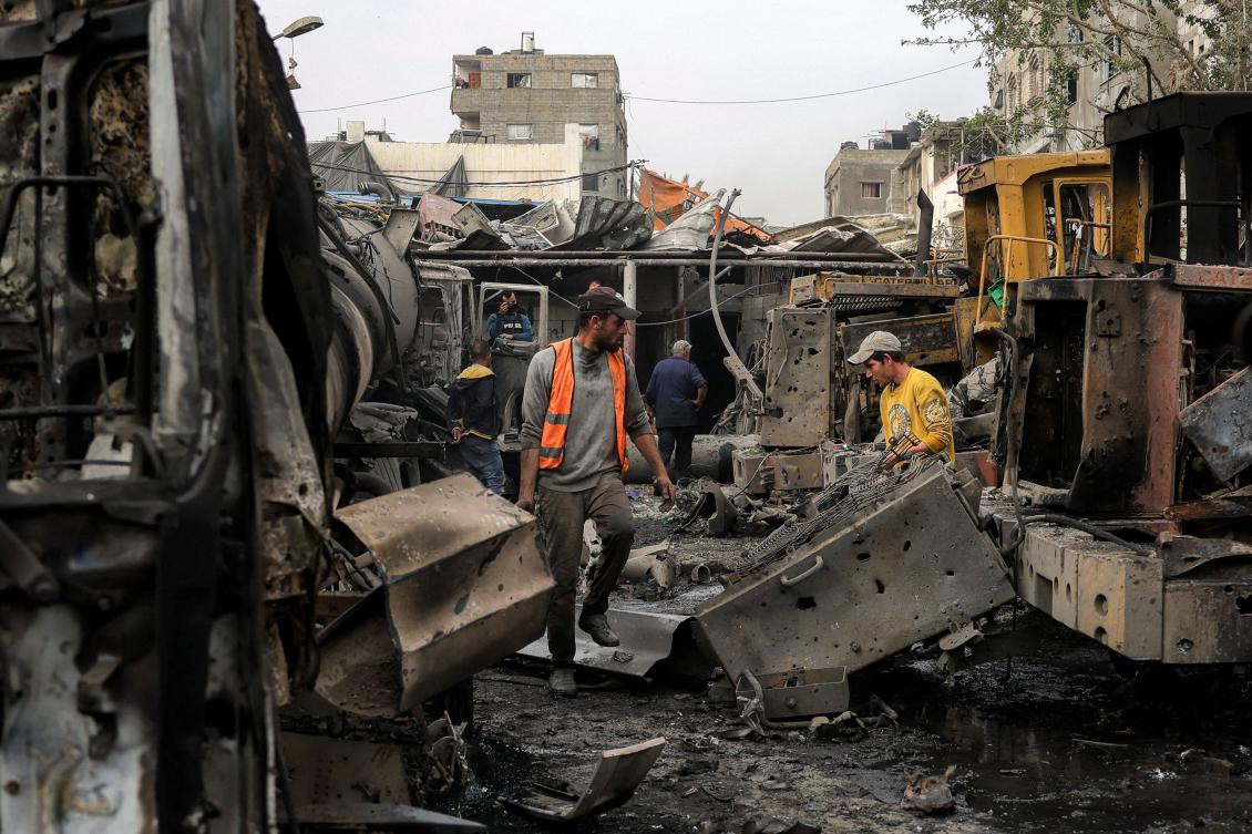 Men inspect destroyed bulldozers and other heavy vehicles at the Jabalia municipality garage, which was hit by Israeli bombardment, in Jabalia in the northern Gaza Strip on April 22, 2025. (AFP)
