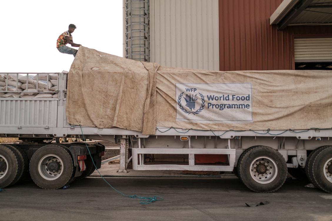 A worker covers a truck full of sacks of grain in a warehouse of the World Food Programme (WFP) in the city of Abala, Ethiopia, on June 09, 2022. (AFP)