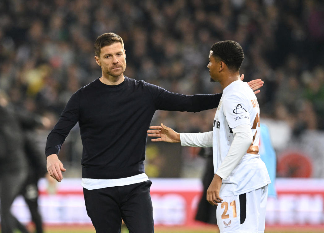 Bayer Leverkusen coach Xabi Alonso and Amine Adli after their Bundesliga match against St. Pauli at Millerntor-Stadion, Hamburg, Apr. 20, 2025. (Reuters)