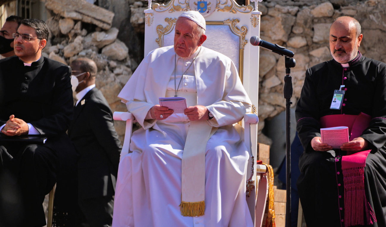 Pope Francis looks on while seated on the podium at the square near the ruins of the Syriac Catholic Church of the Immaculate Conception, in the old city of Iraq's northern Mosul on March 7, 2021. (AFP)