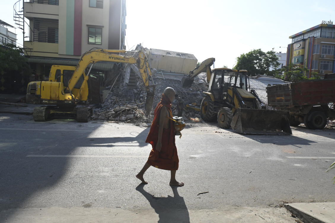 A Buddhist monk walks past the debris of a damaged pagoda in Mandalay following the devastating March 28 earthquake. (AFP)